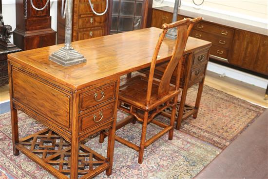 A Chinese elm pedestal desk and matching chair W.168cm